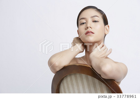 a girl is posing and looking at something 33778961