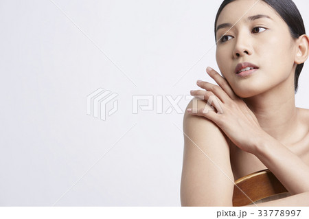 portrait of young model posing with chair on white background 33778997