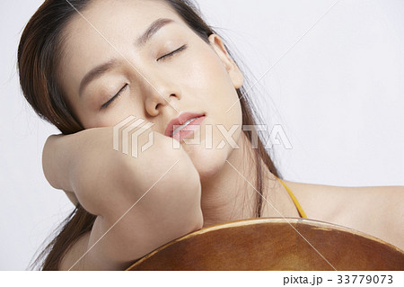 portrait of young woman holding her head and sleeping 33779073