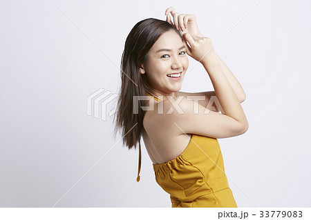 portrait of a woman touching her head and smiling inside portrait of a woman touching her head and smiling inside 33779083