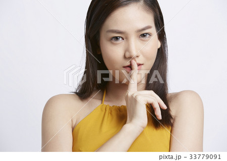 young woman is looking at camera and making silent sign 33779091