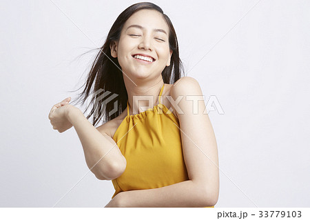 young woman is closing her eyes and smiling 33779103