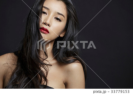 portrait of Thai girl with long black hair and sexy lips on black background portrait of Thai girl with long black hair and sexy lips on black background 33779153