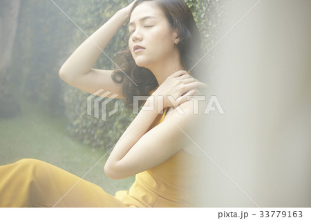 portrait of thai girl sitting and enjoying the fresh air outside 33779163