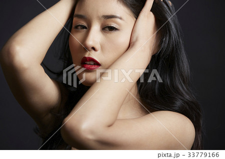 portrait of Asian woman posing photo on black background 33779166