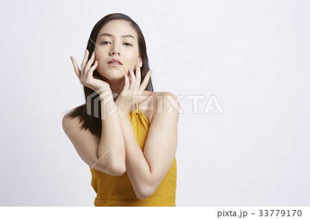 A Thai girl is posing photo with her hands on white background 33779170