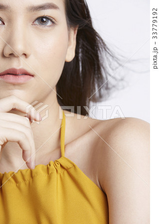 portrait of a girl in yellow dress with chin on hand and thinking portrait of a girl in yellow dress with chin on hand and thinking 33779192