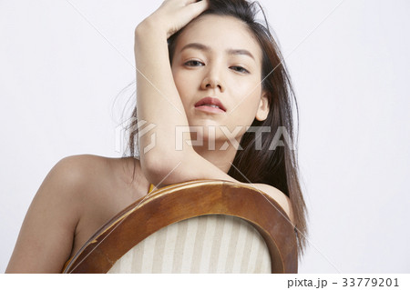portrait of girl touching her hair and posing 33779201