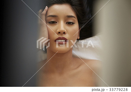 portrait of a beautiful girl touching her head and posing 33779228