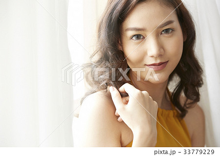 portrait of girl touching her hair and smiling 33779229