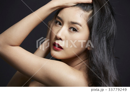 An elegant woman is showing off her beauty in the studio. An elegant woman is showing off her beauty in the studio. 33779249