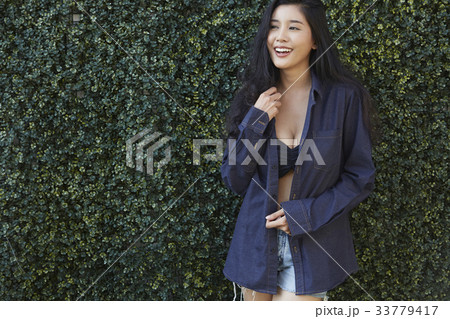 portrait of a sexy girl standing outside and smiling happily 33779417