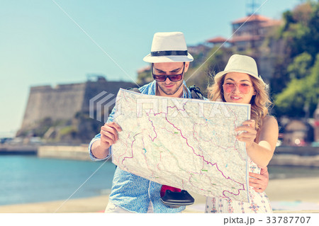 Multiethnic traveler couple using generic local 33787707