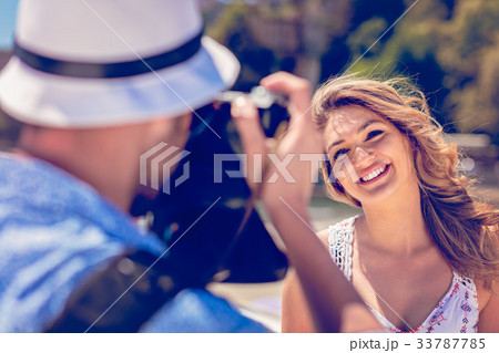 Young man tourist take photo of his girlfriend Young man tourist take photo of his girlfriend 33787785