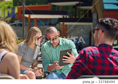 Beautiful stylish friends are using a digital 33788494
