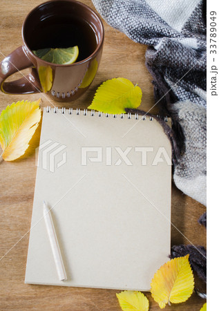 A cup of tea and empty notebook for sketch. 33789049