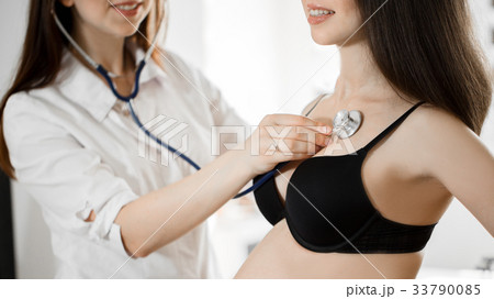 female medicine doctor holding stethoscope to 33790085