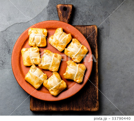 Mini chilean empanadas on clay plate with typical 33790440