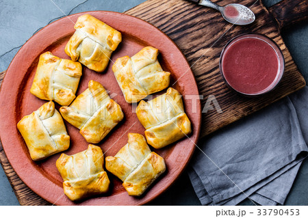 Mini chilean empanadas on clay plate with typical 33790453