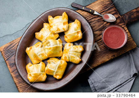 Mini chilean empanadas on clay plate with typical 33790464