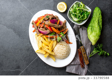 Peruvian dish Lomo saltado - beef tenderloin with 33790588