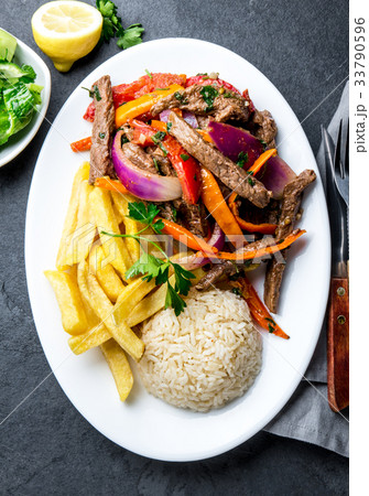 Peruvian dish Lomo saltado - beef tenderloin with Peruvian dish Lomo saltado - beef tenderloin with 33790596