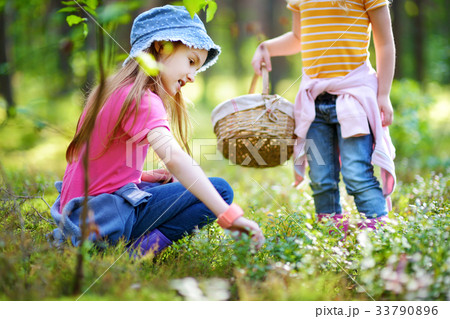 Two funny little sisters having fun during forest hike 33790896
