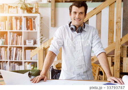 Young man standing in creative office Young man standing in creative office 33793787