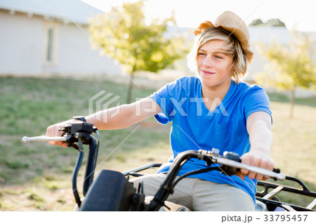 Boy riding farm truck in vineyard 33795457