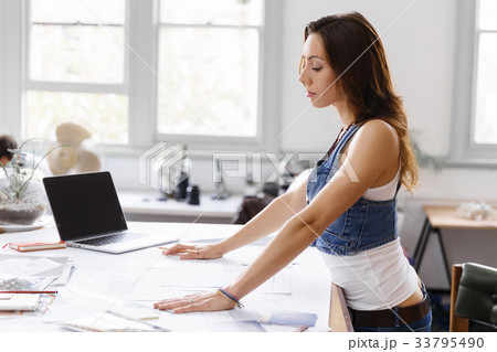 Young woman standing in creative office Young woman standing in creative office 33795490