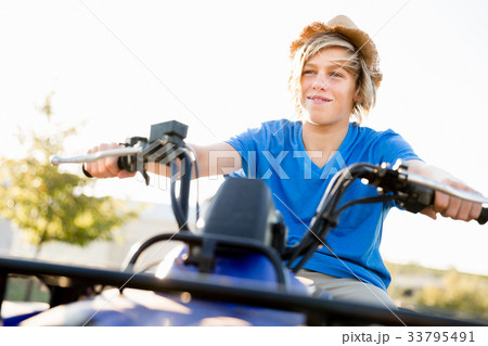 Boy riding farm truck in vineyard 33795491