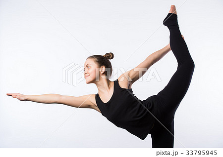 Attractive Woman doing Standing Bow Yoga Pose Attractive Woman doing Standing Bow Yoga Pose 33795945