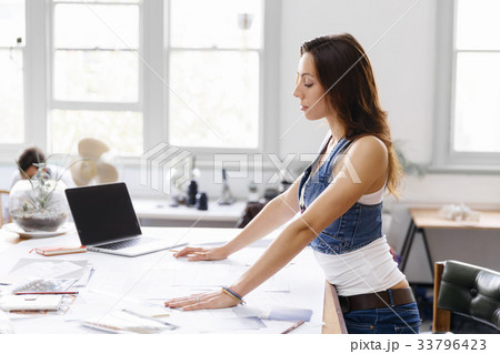 Young woman standing in creative office Young woman standing in creative office 33796423