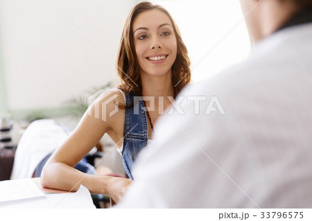 Young woman in office talking to her colleague Young woman in office talking to her colleague 33796575