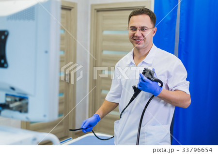 proctologist holding anoscope at hospital ward proctologist holding anoscope at hospital ward 33796654