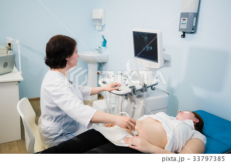 Doctor using ultrasound and screening stomach of 33797385