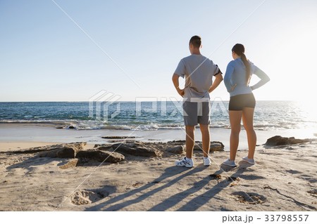 Young couple on beach training together 33798557