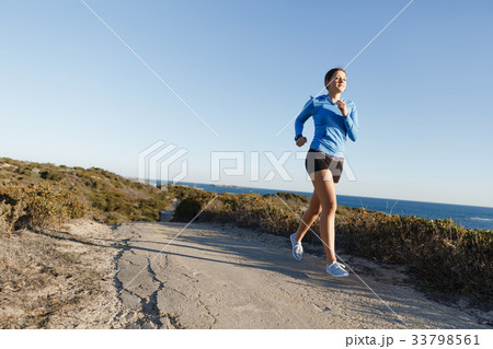 Sport runner jogging on beach working out 33798561