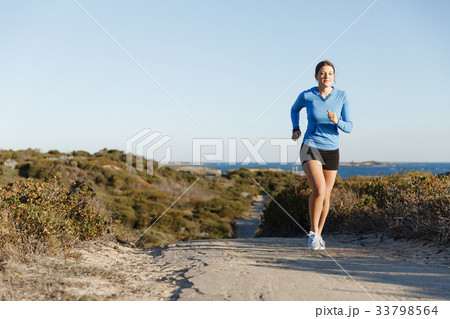 Sport runner jogging on beach working out 33798564