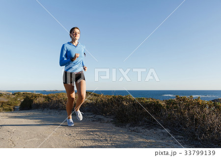 Sport runner jogging on beach working out Sport runner jogging on beach working out 33799139
