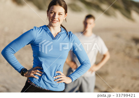 Young couple on beach training together Young couple on beach training together 33799421