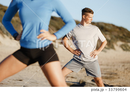 Young couple on beach training together 33799604