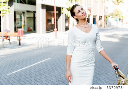 Business woman pulling suitcase bag walking in city 33799784