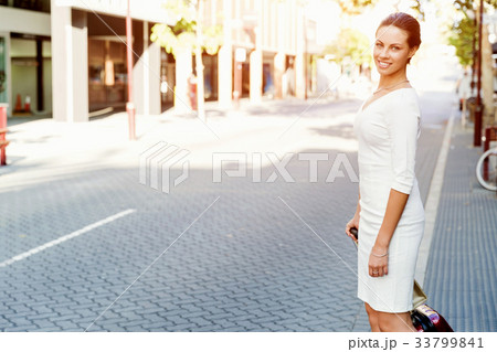 Business woman pulling suitcase bag walking in city Business woman pulling suitcase bag walking in city 33799841