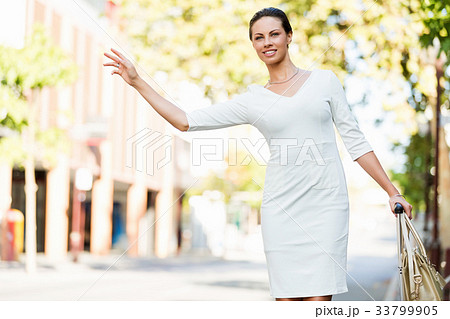 Business woman pulling suitcase bag walking in city 33799905