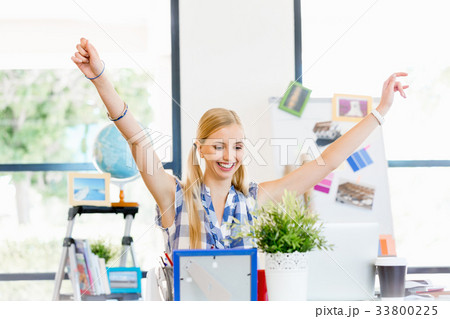 Happy young woman in office Happy young woman in office 33800225