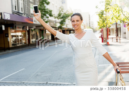 Business woman pulling suitcase bag walking in city 33800458
