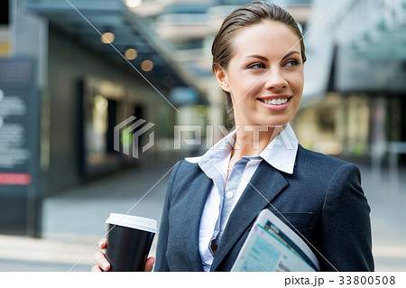 Portrait of business woman walking and smiling outdoor 33800508