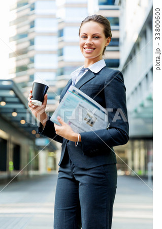 Portrait of business woman walking and smiling outdoor Portrait of business woman walking and smiling outdoor 33800600