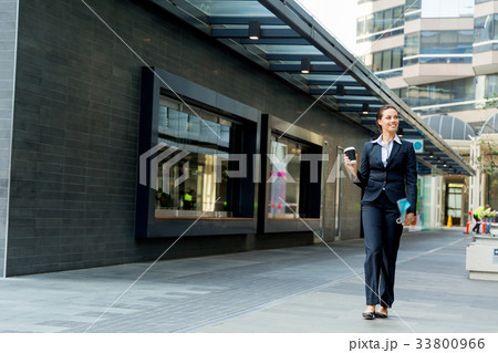 Portrait of business woman walking and smiling outdoor Portrait of business woman walking and smiling outdoor 33800966